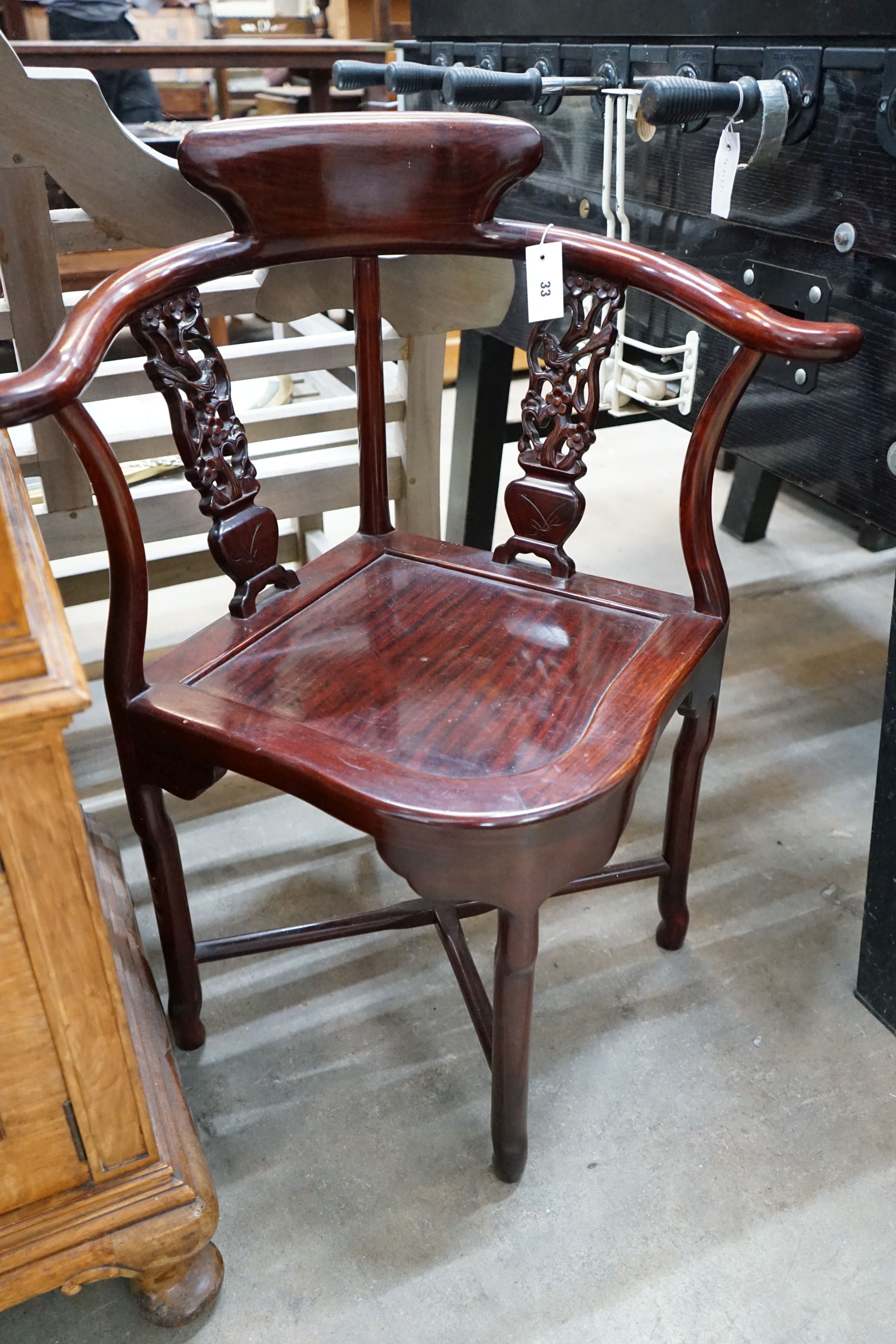 A Chinese carved corner elbow chair, width 69cm, depth 54cm, height 86cm